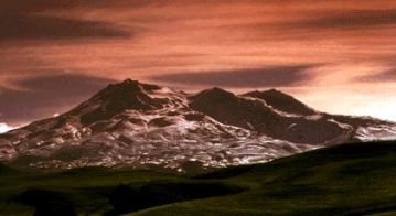 The sun sets over Mt. Ruapehu, painting the volcanic landscape fiery red. This shot is NOT related to Lord of the Rings and does NOT have any special effects!